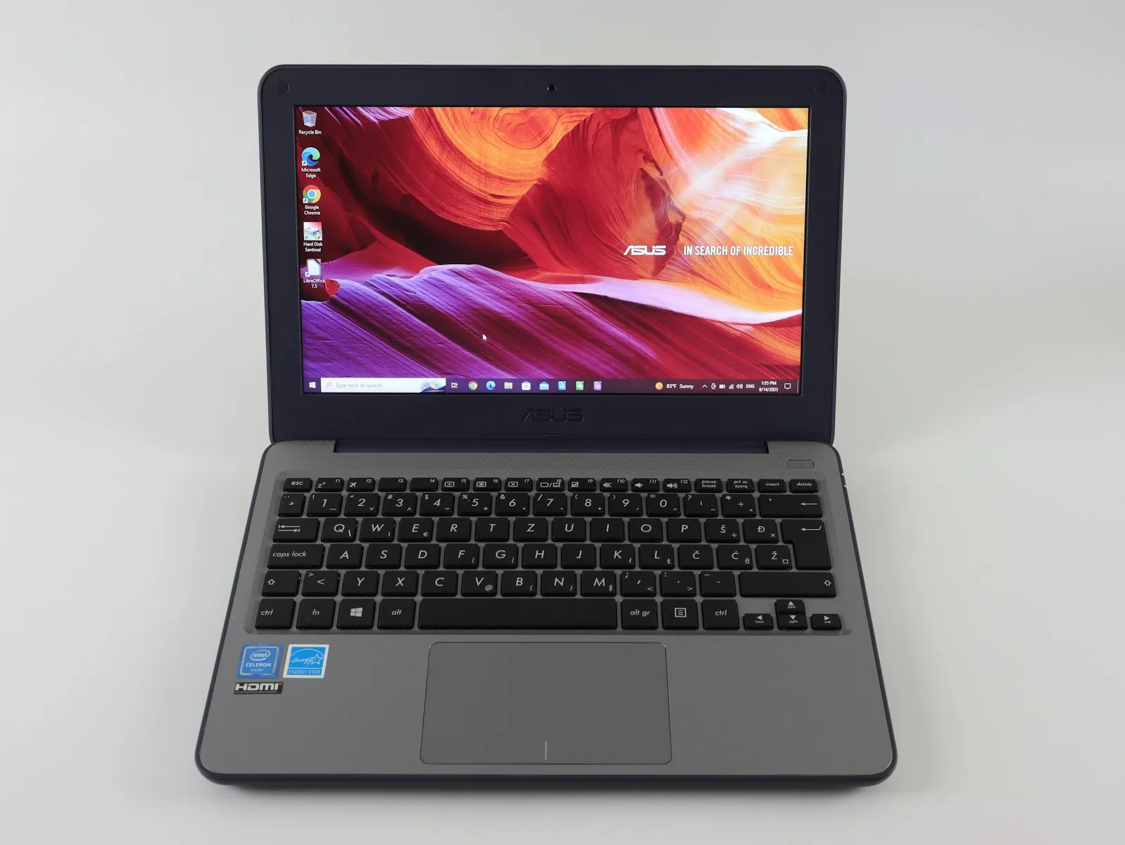 a laptop computer sitting on top of a white table
