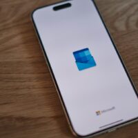 A white cell phone sitting on top of a wooden table
